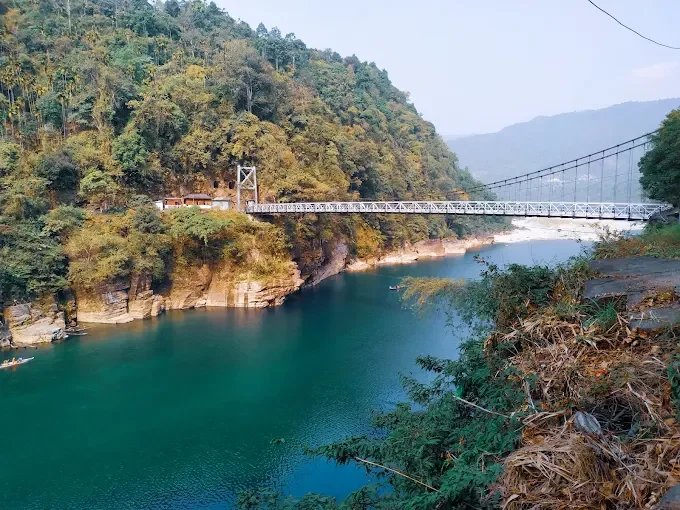 "Dawki Suspension Bridge spanning across the clear turquoise Umngot River in Meghalaya"