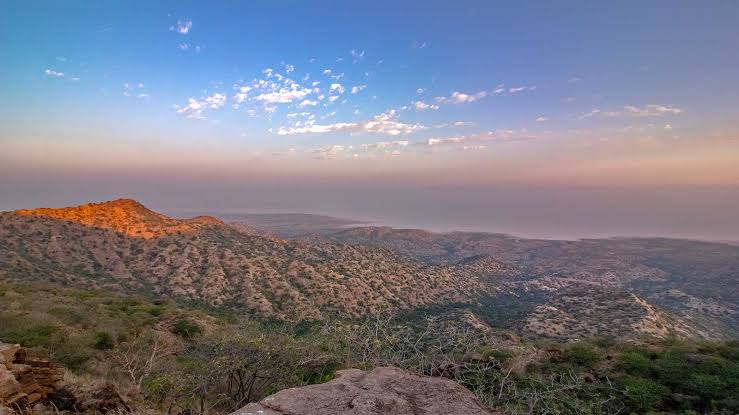 Panoramic view of the vast valleys and distant salt desert horizon from the peak of Kalo Dungar Black Hill viewpoint in Kutch
